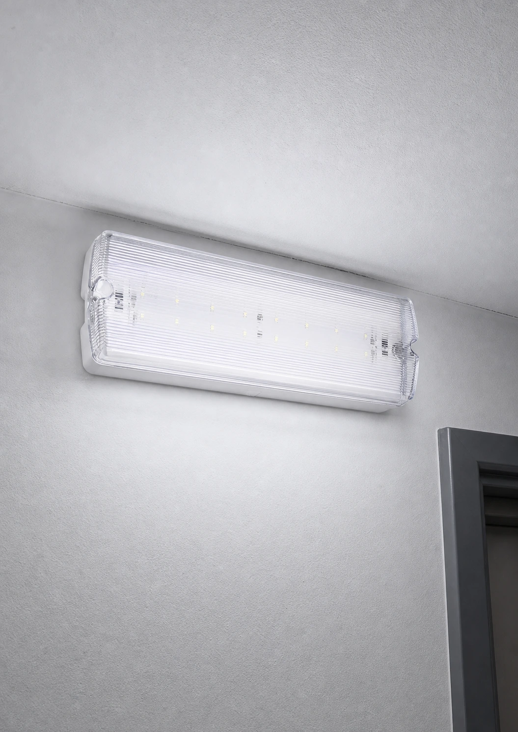 Rectangular emergency bulkhead installed above a commercial doorway