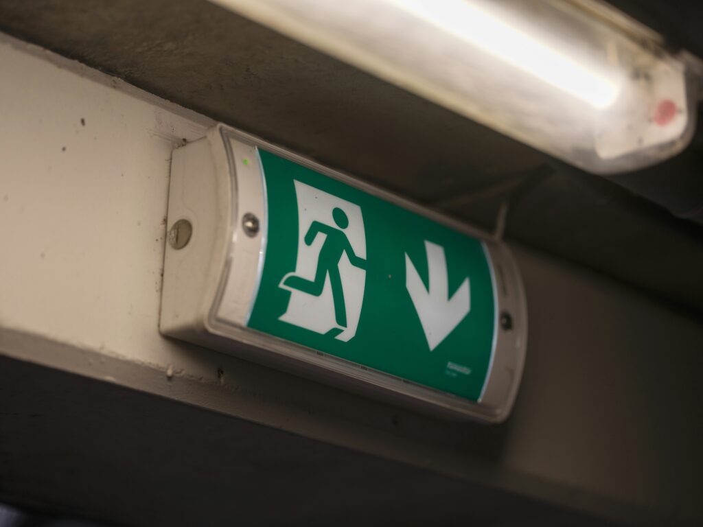 A close up of a green and white sign on a wall